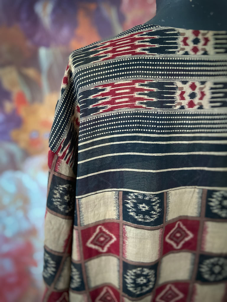 Red and black harlequin ikat print fine cotton voile kaftan dress. Fully lined, with deep pockets, wide sleeves and V neck. Bohemian styles sustainably created from antique and vintage textiles by the Pavilion Parade studio