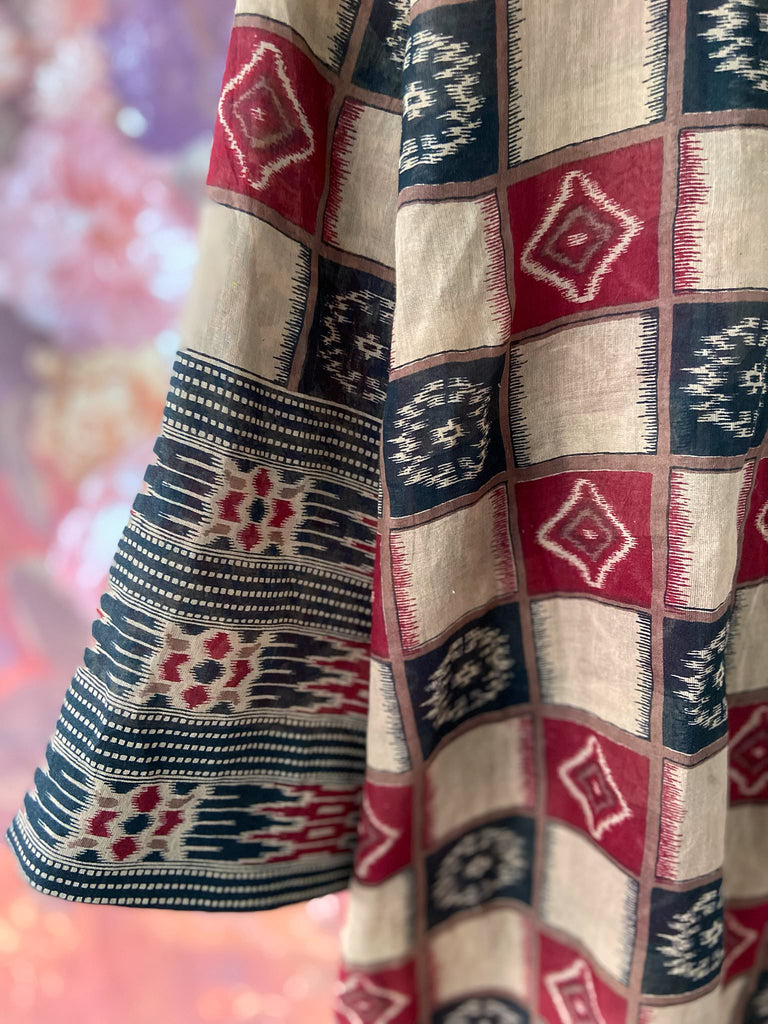 Red and black harlequin ikat print fine cotton voile kaftan dress. Fully lined, with deep pockets, wide sleeves and V neck. Bohemian styles sustainably created from antique and vintage textiles by the Pavilion Parade studio