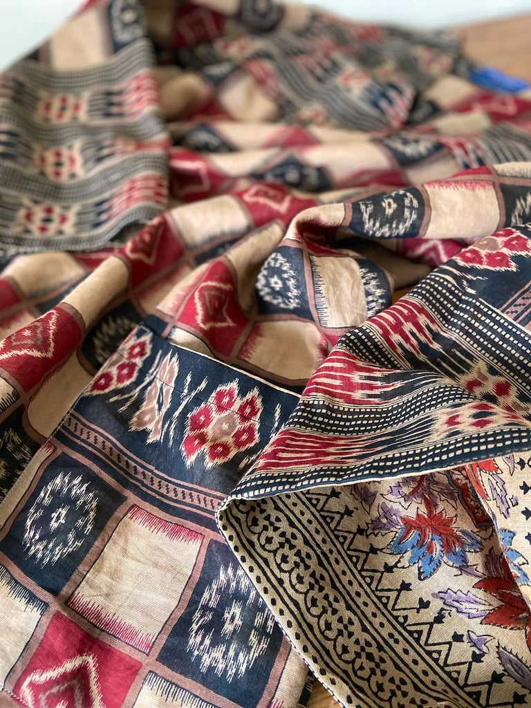 Red and black harlequin ikat print fine cotton voile kaftan dress. Fully lined, with deep pockets, wide sleeves and V neck. Bohemian styles sustainably created from antique and vintage textiles by the Pavilion Parade studio