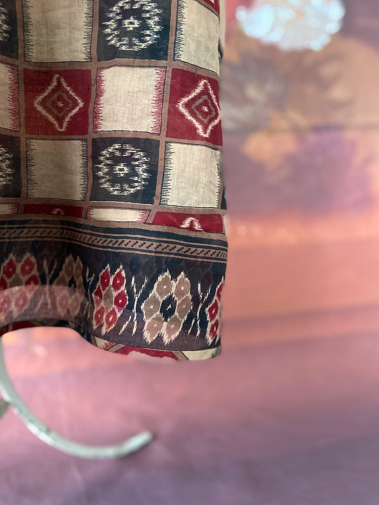 Red and black harlequin ikat print fine cotton voile kaftan dress. Fully lined, with deep pockets, wide sleeves and V neck. Bohemian styles sustainably created from antique and vintage textiles by the Pavilion Parade studio