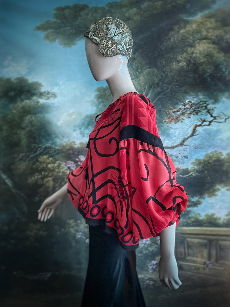 Scarlet red and ebony black silk georgette blouse with long full sleeves and adjustable drawstring neckline. Bohemian styles sustainably created from antique and vintage textiles by the Pavilion Parade studio. 