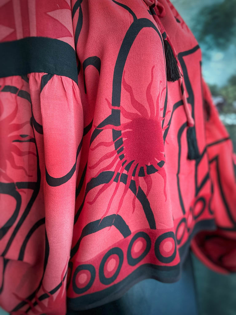 Scarlet red and ebony black silk georgette blouse with long full sleeves and adjustable drawstring neckline. Bohemian styles sustainably created from antique and vintage textiles by the Pavilion Parade studio. 