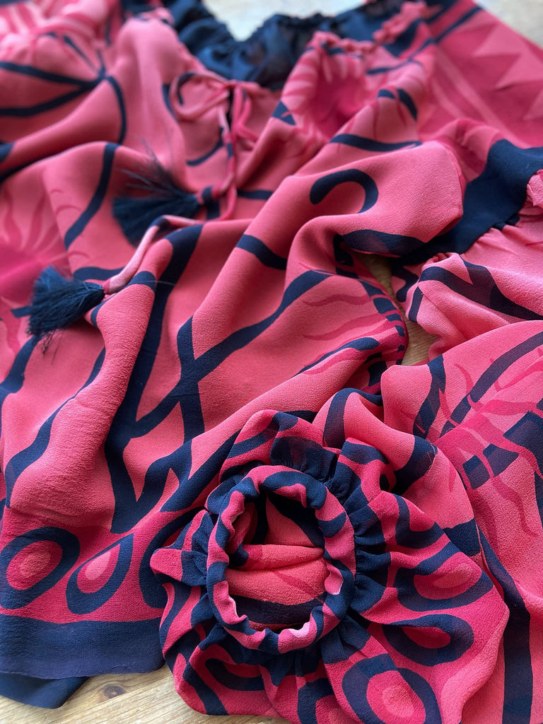 Scarlet red and ebony black silk georgette blouse with long full sleeves and adjustable drawstring neckline. Bohemian styles sustainably created from antique and vintage textiles by the Pavilion Parade studio. 