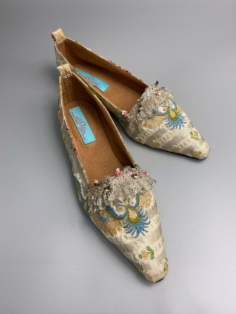 Regency dancing slipper inspired flat shoes created from an early 18th century  silk with gold and silver thread weave highlighted in cerulean blue. Embellished with rare 18th century silk floss and silver thread fly braid and  delicate antique silver lace. Bohemian style sustainably created from antique textiles by the Pavilion Parade Studio.