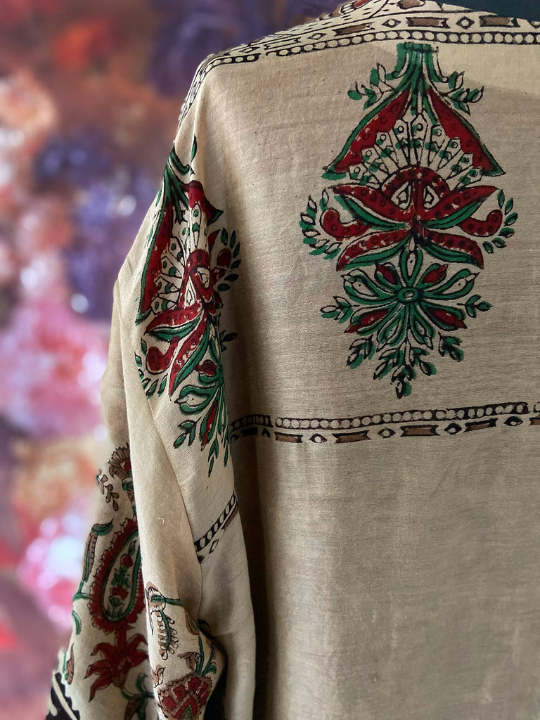 Reversible block printed kalamkari cotton kaftan dress. Slate blue and rust Indienne paisley and floral motif. Deep pockets, wide sleeves and a relaxed fit. Bohemian style created from vintage and antique textiles by the Pavilion Parade studio.