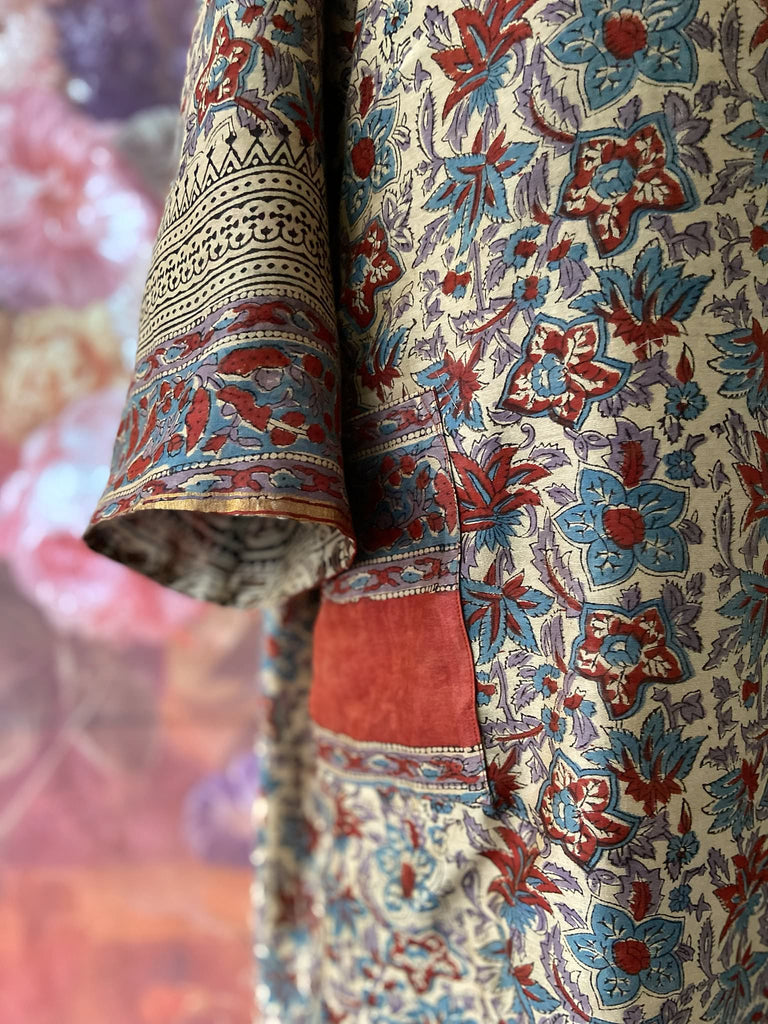 Reversible block printed kalamkari cotton kaftan dress. Slate blue and rust Indienne paisley and floral motif. Deep pockets, wide sleeves and a relaxed fit. Bohemian style created from vintage and antique textiles by the Pavilion Parade studio.