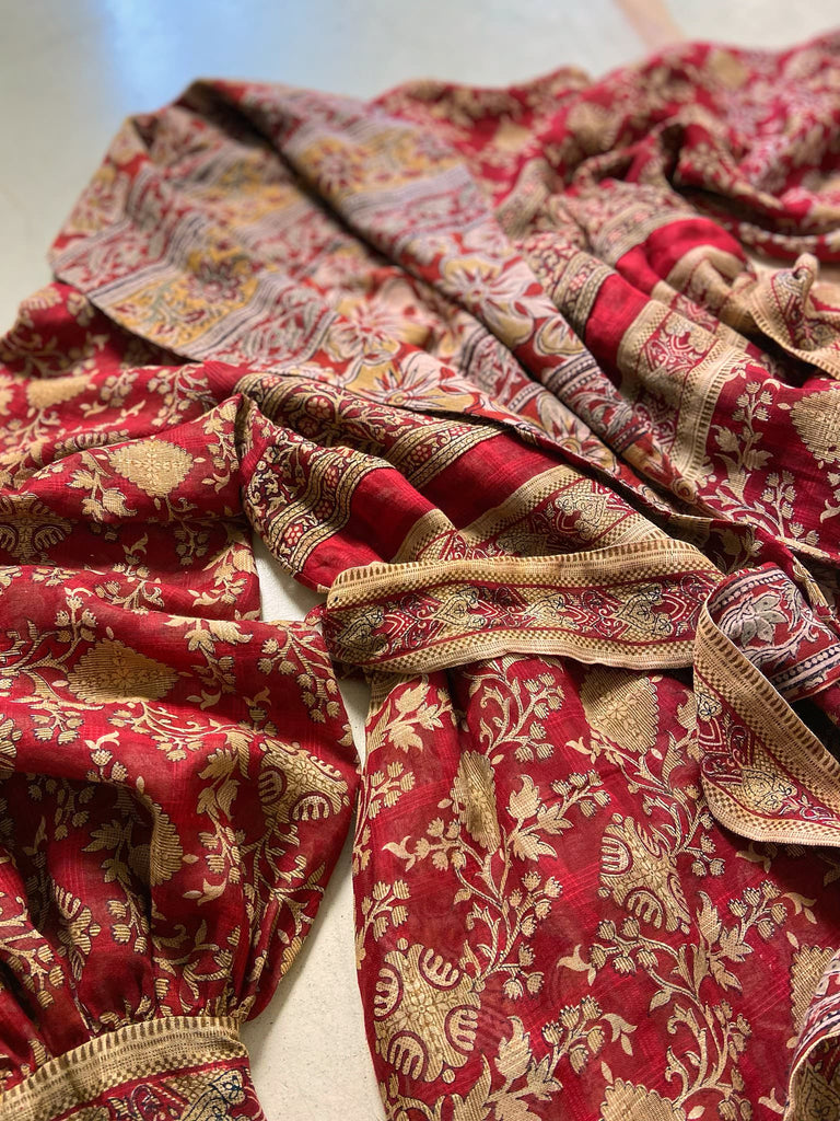 Reversible red and golden yellow cotton kalamkari and voile robe with balloon sleeves, side pockets, and tassel sash. Unique bohemian style sustainably created from vintage textiles by the Pavilion Parade Studio