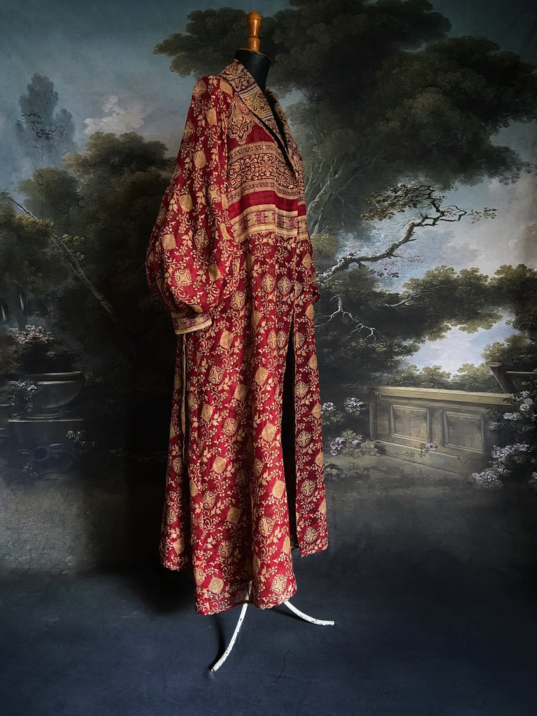 Reversible red and golden yellow cotton kalamkari and voile robe with balloon sleeves, side pockets, and tassel sash. Unique bohemian style sustainably created from vintage textiles by the Pavilion Parade Studio