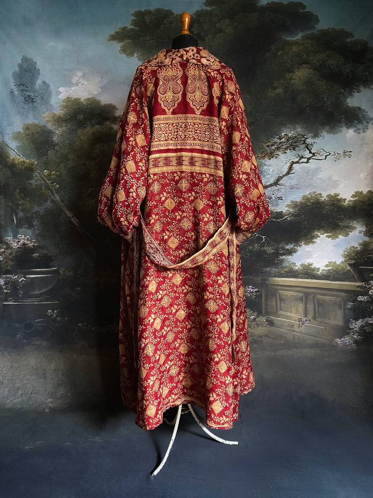 Reversible red and golden yellow cotton kalamkari and voile robe with balloon sleeves, side pockets, and tassel sash. Unique bohemian style sustainably created from vintage textiles by the Pavilion Parade Studio