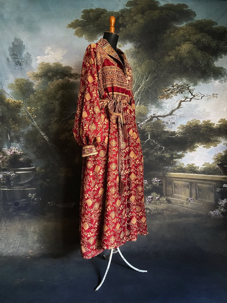 Reversible red and golden yellow cotton kalamkari and voile robe with balloon sleeves, side pockets, and tassel sash. Unique bohemian style sustainably created from vintage textiles by the Pavilion Parade Studio