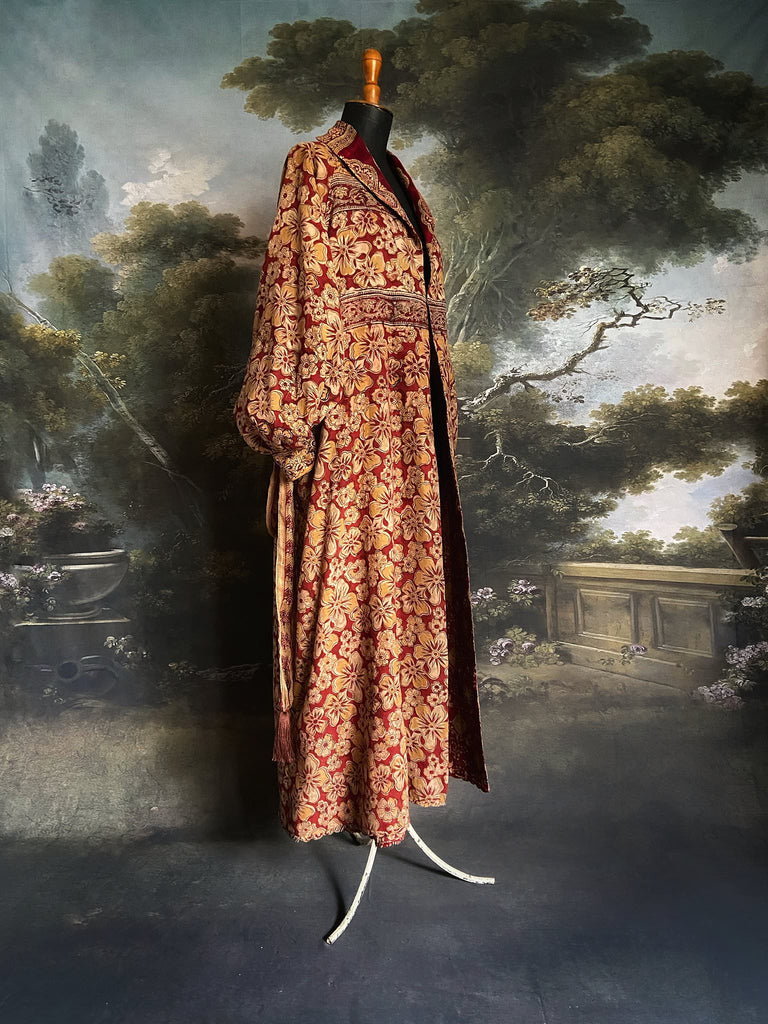 Reversible red and golden yellow cotton kalamkari and voile robe with balloon sleeves, side pockets, and tassel sash. Unique bohemian style sustainably created from vintage textiles by the Pavilion Parade Studio