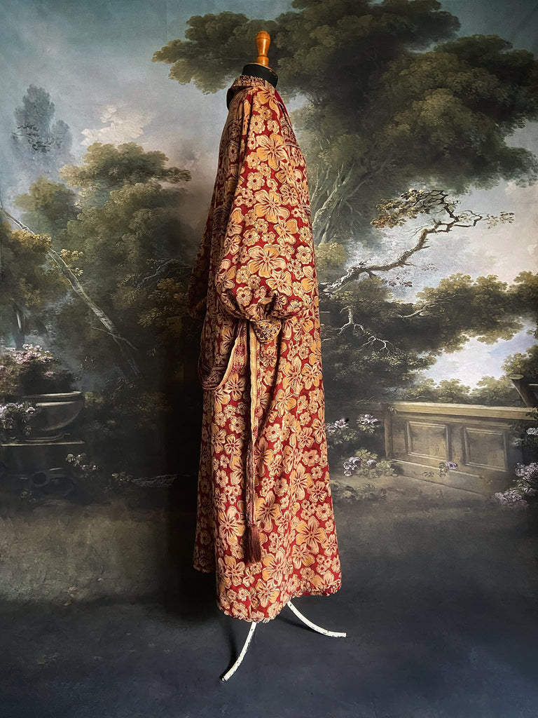 Reversible red and golden yellow cotton kalamkari and voile robe with balloon sleeves, side pockets, and tassel sash. Unique bohemian style sustainably created from vintage textiles by the Pavilion Parade Studio