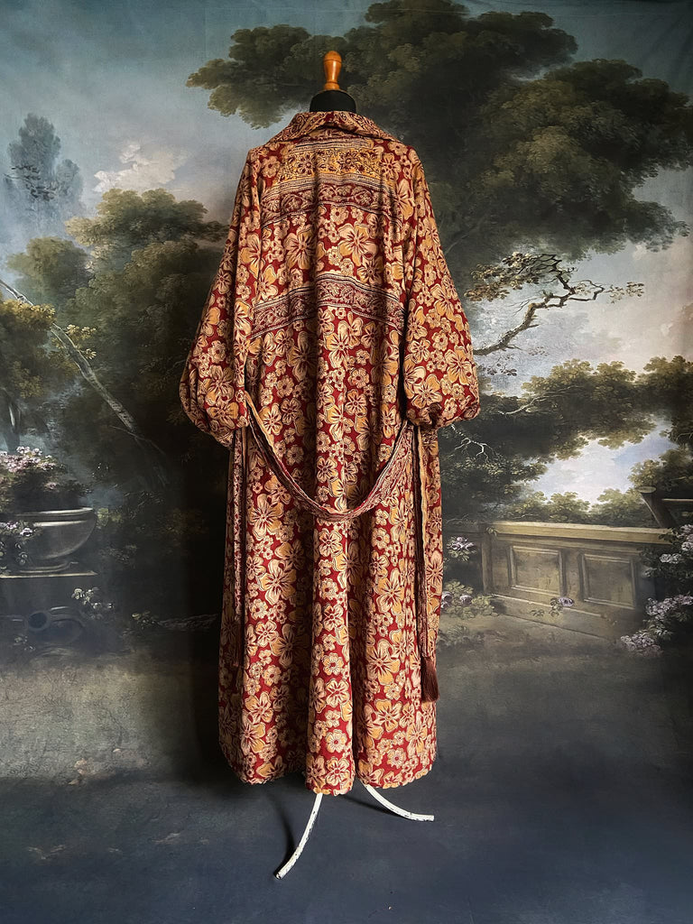 Reversible red and golden yellow cotton kalamkari and voile robe with balloon sleeves, side pockets, and tassel sash. Unique bohemian style sustainably created from vintage textiles by the Pavilion Parade Studio