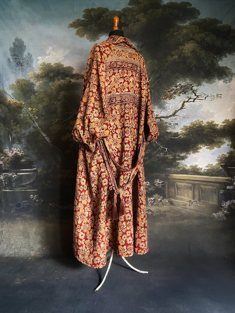Reversible red and golden yellow cotton kalamkari and voile robe with balloon sleeves, side pockets, and tassel sash. Unique bohemian style sustainably created from vintage textiles by the Pavilion Parade Studio