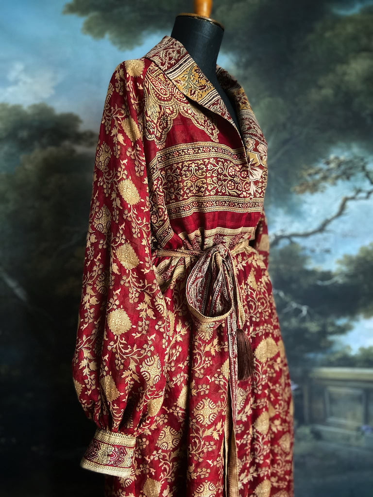 Reversible red and golden yellow cotton kalamkari and voile robe with balloon sleeves, side pockets, and tassel sash. Unique bohemian style sustainably created from vintage textiles by the Pavilion Parade Studio