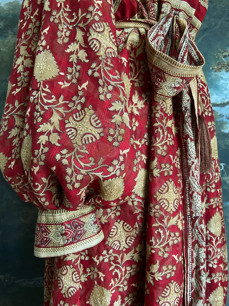 Reversible red and golden yellow cotton kalamkari and voile robe with balloon sleeves, side pockets, and tassel sash. Unique bohemian style sustainably created from vintage textiles by the Pavilion Parade Studio