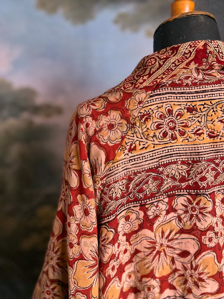 Reversible red and golden yellow cotton kalamkari and voile robe with balloon sleeves, side pockets, and tassel sash. Unique bohemian style sustainably created from vintage textiles by the Pavilion Parade Studio
