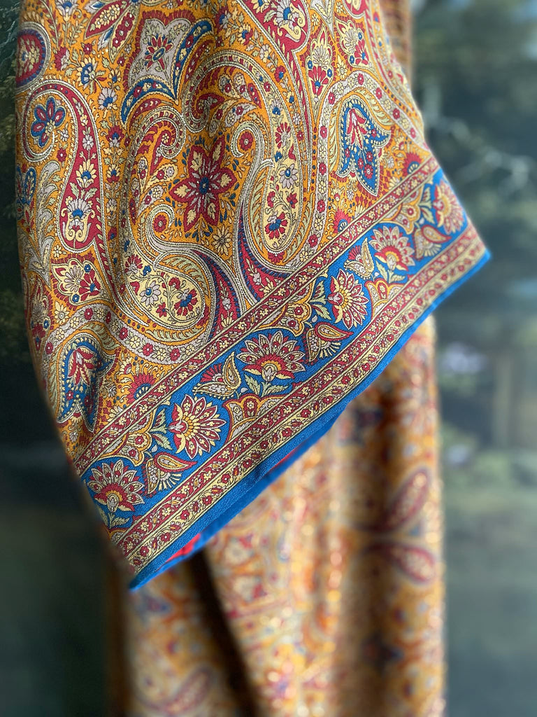 Saffron, red, and cerulean blue paisley silk crepe 1920s inspired kimono robe. Bohemian styles sustainably created from vintage textiles by the Pavilion Parade studio.