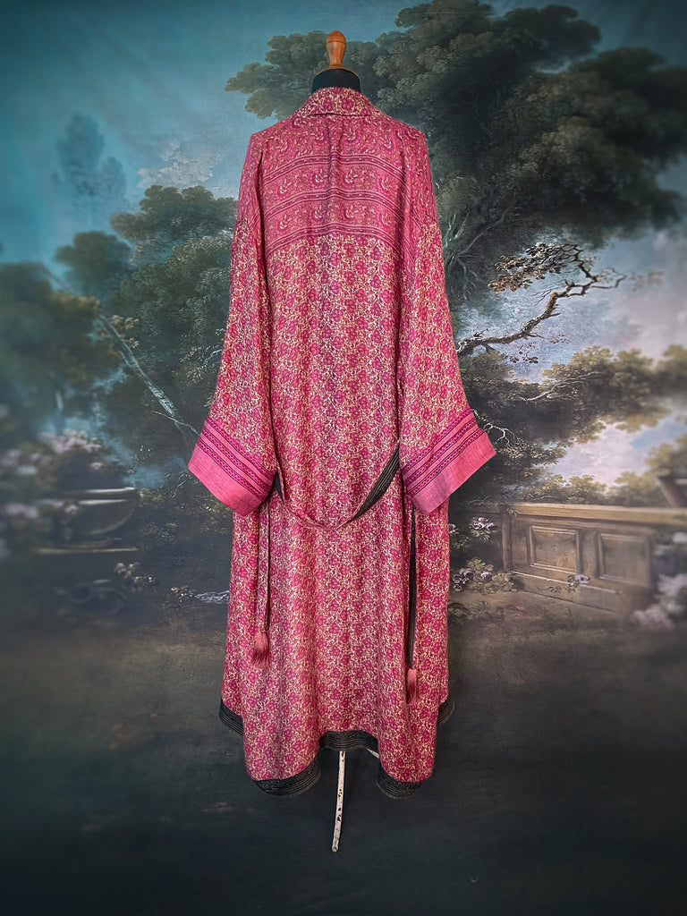 Rose pink silk lined fine wool dressing robe with wide sleeves, deep pockets and tassel sash. Bohemian styles sustainably created from antique and vintage textiles by the Pavilion Parade studio