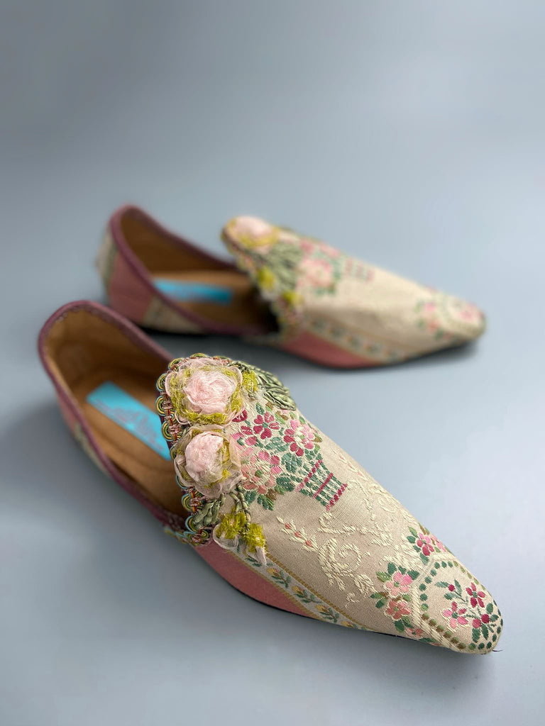 Dusty pink and cream silk pointed toe shoes with timeworn ribbon roses in the Georgian style. Embellished with antique braids. Bohemian styles sustainably created from antique textiles by Pavilion Parade.