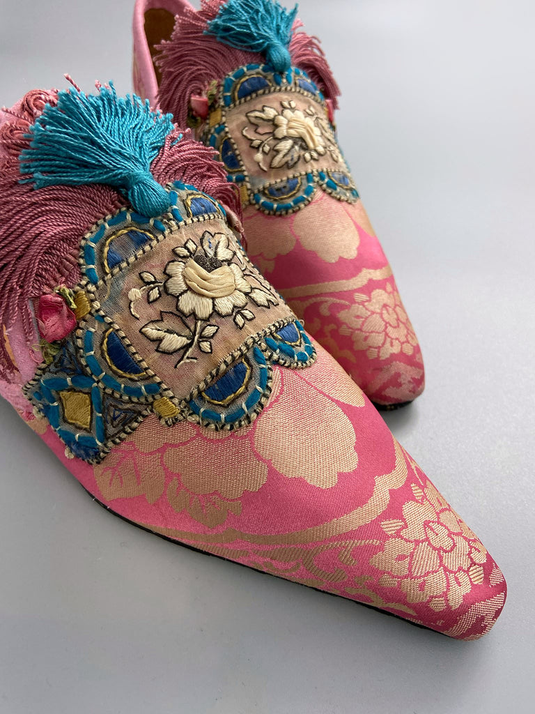 Rose pink and blue tassel silk brocade pointed toe shoes sustainably created using antique textiles and embellishments by the Pavilion Parade studio.