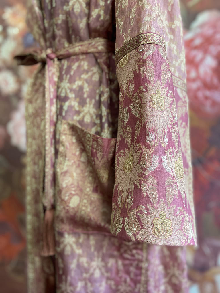 Rose pink and platinum lightweight luxury silk wrapper robe with wide sleeves, large patch pockets and tassel sash. Bohemian style created from antique and vintage textiles by the Pavilion Parade studio.