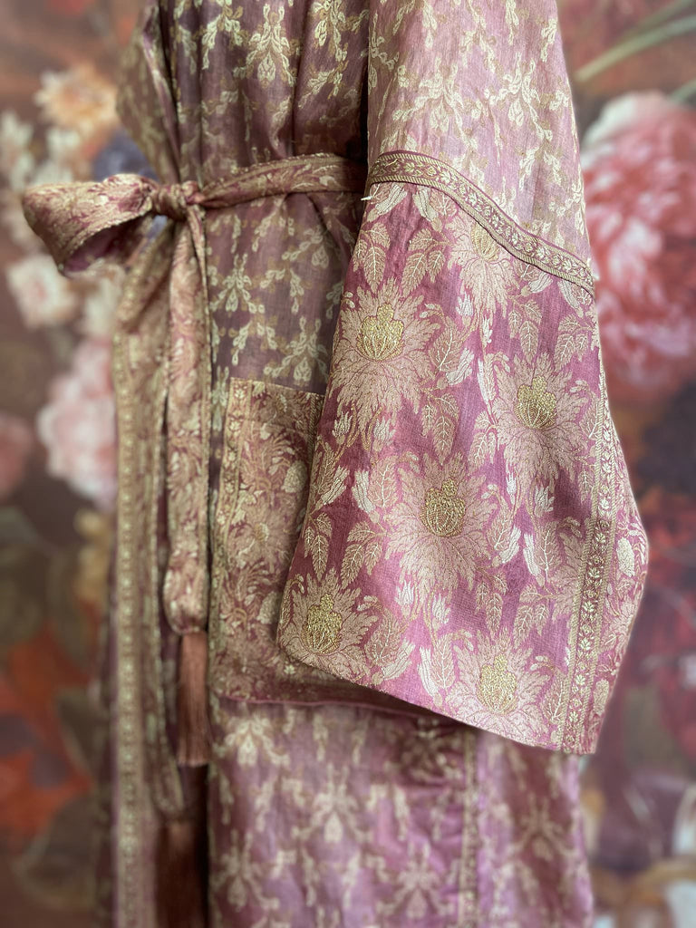 Rose pink and platinum lightweight luxury silk wrapper robe with wide sleeves, large patch pockets and tassel sash. Bohemian style created from antique and vintage textiles by the Pavilion Parade studio.