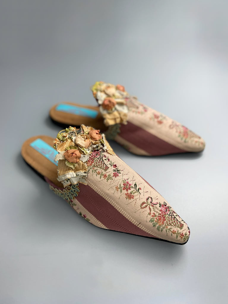 Mauve pink and cream silk pointed toe shoes with antique C18th pinked dress trim and timeworn ribbon roses in the Georgian style. Embellished with antique braids. Bohemian styles sustainably created from antique textiles by Pavilion Parade.
