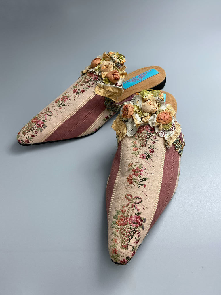 Mauve pink and cream silk pointed toe shoes with antique C18th pinked dress trim and timeworn ribbon roses in the Georgian style. Embellished with antique braids. Bohemian styles sustainably created from antique textiles by Pavilion Parade.