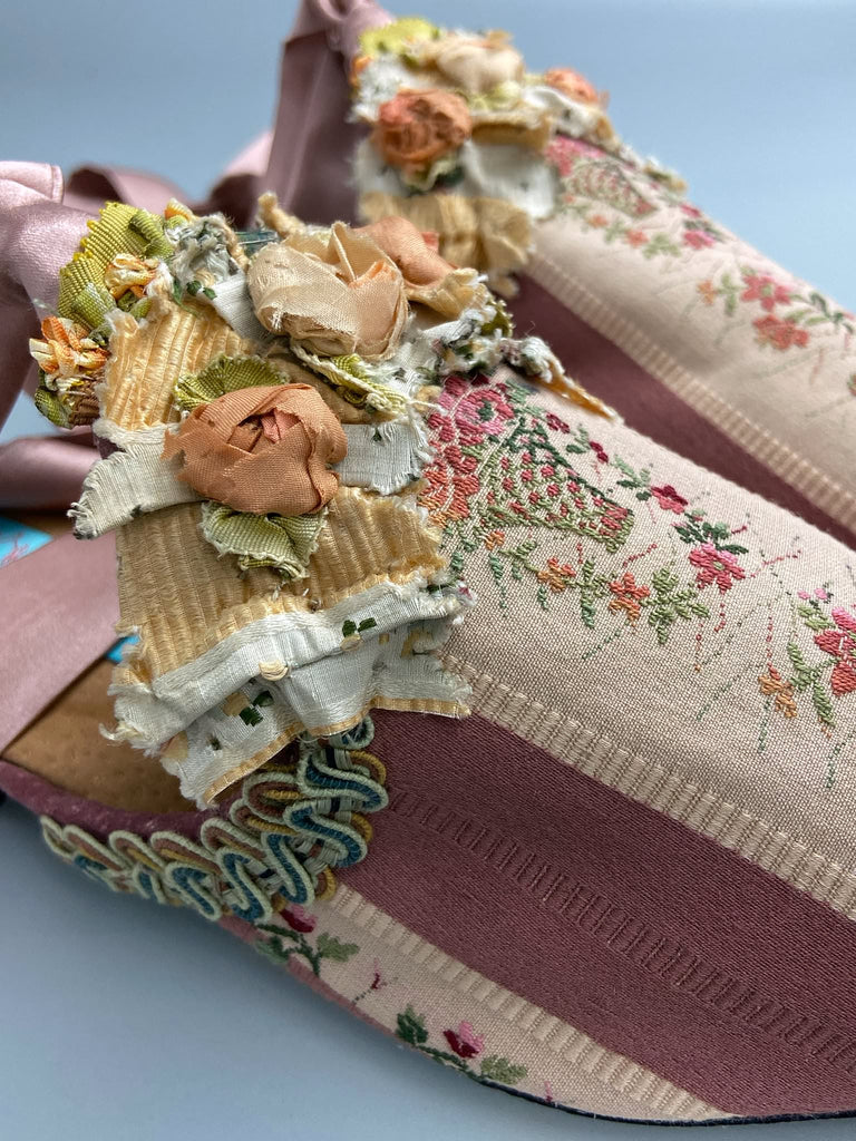 Mauve pink and cream silk pointed toe shoes with antique C18th pinked dress trim and timeworn ribbon roses in the Georgian style. Embellished with antique braids. Bohemian styles sustainably created from antique textiles by Pavilion Parade.