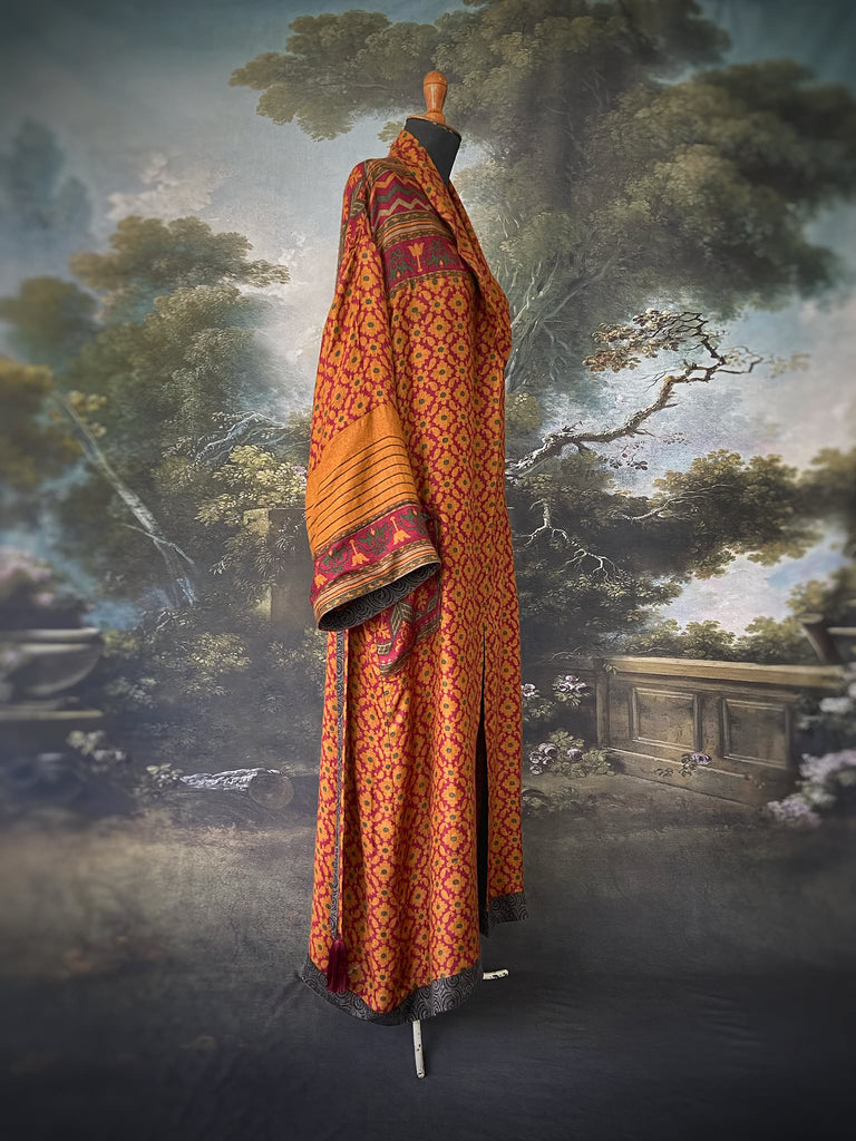 Vibrant saffron and carnelian red fine wool and silk robe with wide sleeves, patch pockets and tassel sash. Bohemian style created from antique and vintage textiles by the Pavilion Parade Studio