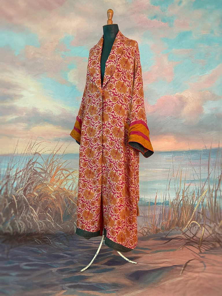Saffron and hot pink fine wool dressing robe lined with silk. Wide sleeves, patch pockets and tassel sash belt. Bohemian styles sustainably created from antique and vintage textiles by the Pavilion Parade studio.