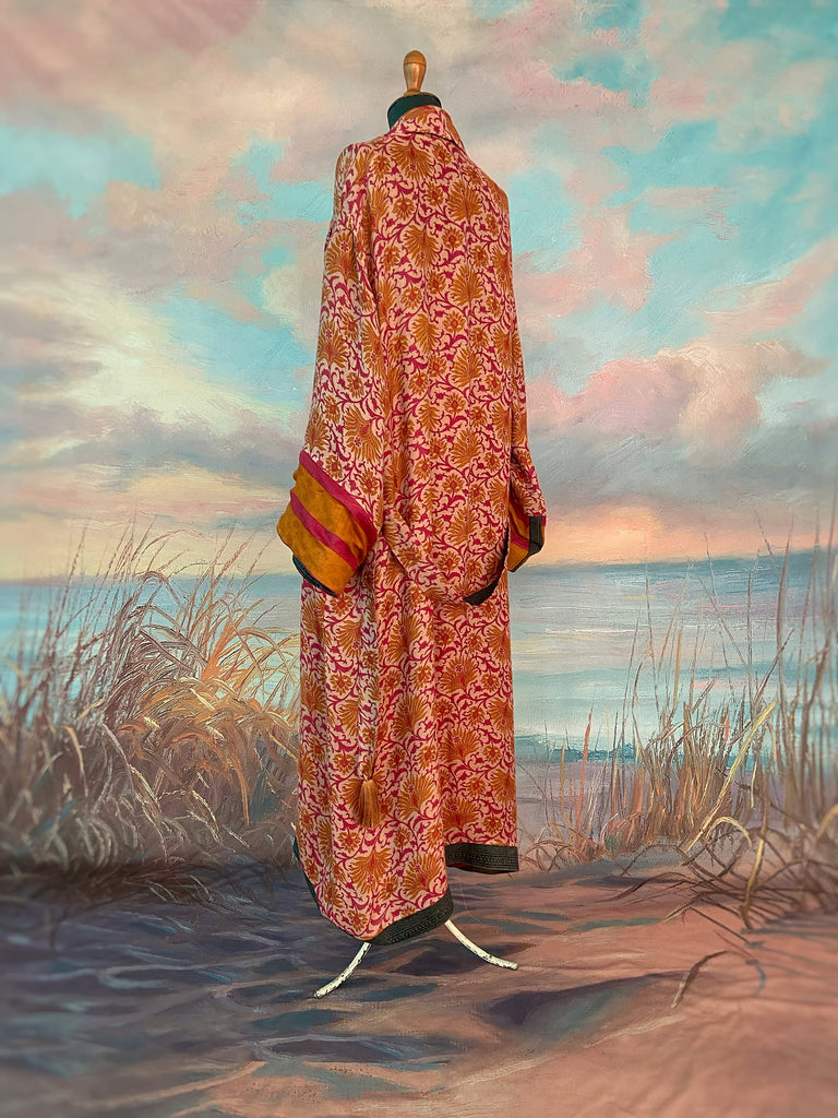 Saffron and hot pink fine wool dressing robe lined with silk. Wide sleeves, patch pockets and tassel sash belt. Bohemian styles sustainably created from antique and vintage textiles by the Pavilion Parade studio.