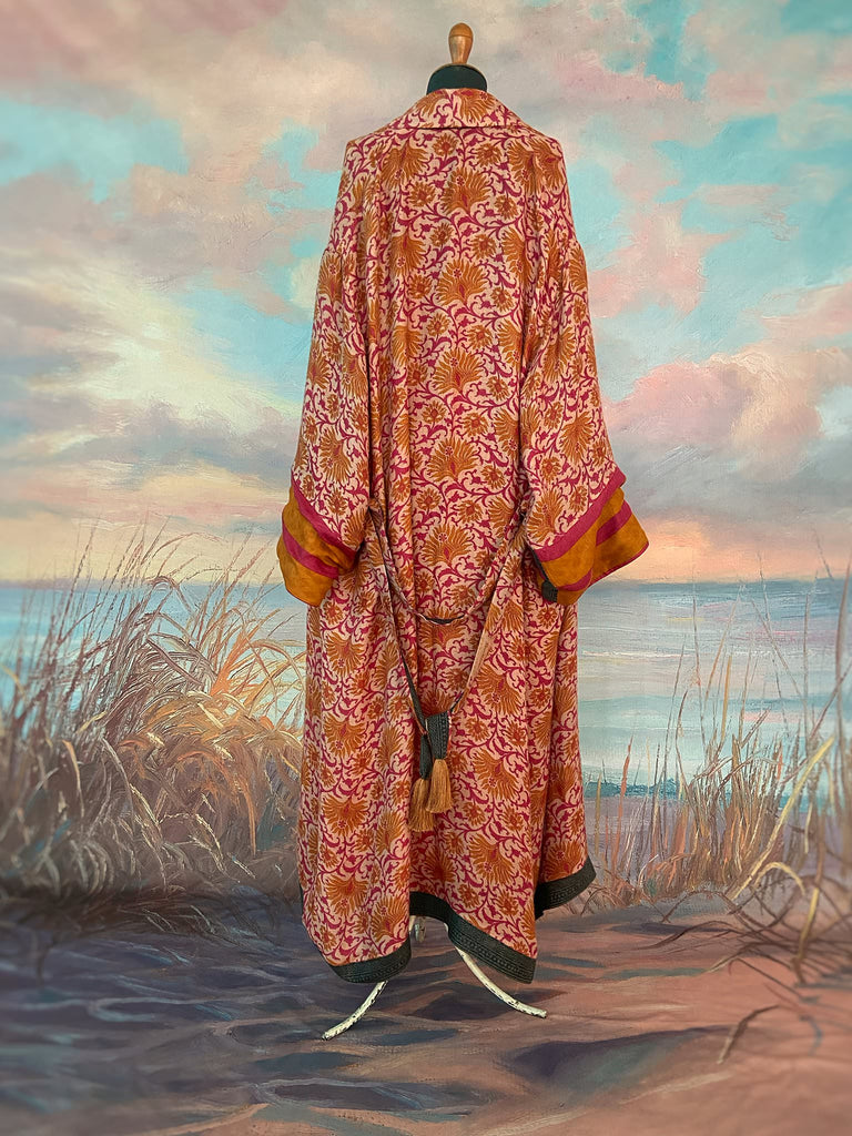 Saffron and hot pink fine wool dressing robe lined with silk. Wide sleeves, patch pockets and tassel sash belt. Bohemian styles sustainably created from antique and vintage textiles by the Pavilion Parade studio.