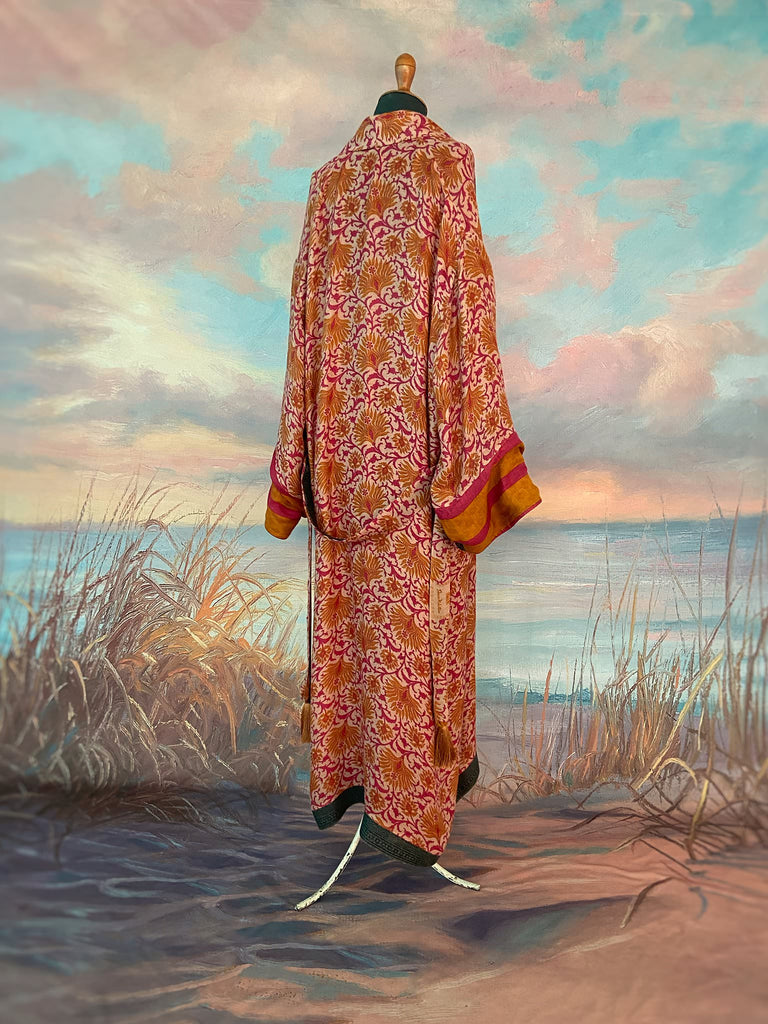 Saffron and hot pink fine wool dressing robe lined with silk. Wide sleeves, patch pockets and tassel sash belt. Bohemian styles sustainably created from antique and vintage textiles by the Pavilion Parade studio.