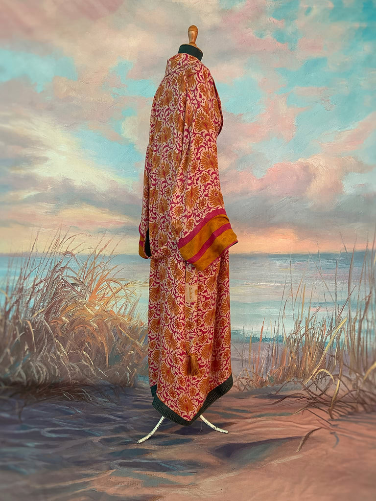 Saffron and hot pink fine wool dressing robe lined with silk. Wide sleeves, patch pockets and tassel sash belt. Bohemian styles sustainably created from antique and vintage textiles by the Pavilion Parade studio.