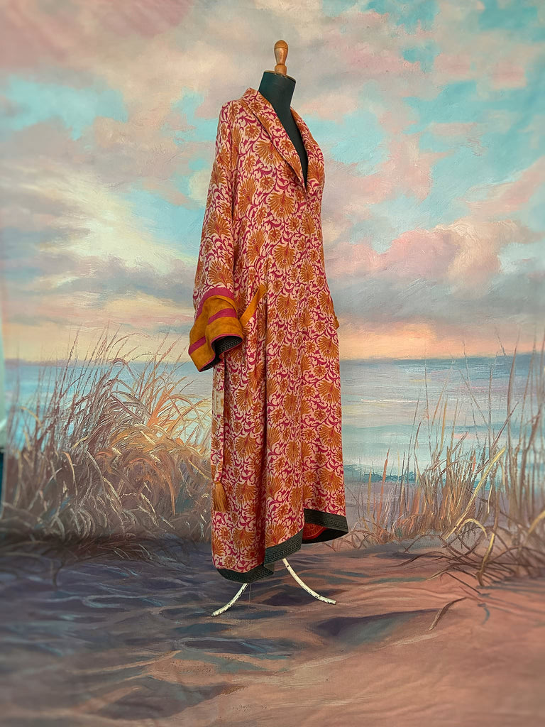 Saffron and hot pink fine wool dressing robe lined with silk. Wide sleeves, patch pockets and tassel sash belt. Bohemian styles sustainably created from antique and vintage textiles by the Pavilion Parade studio.