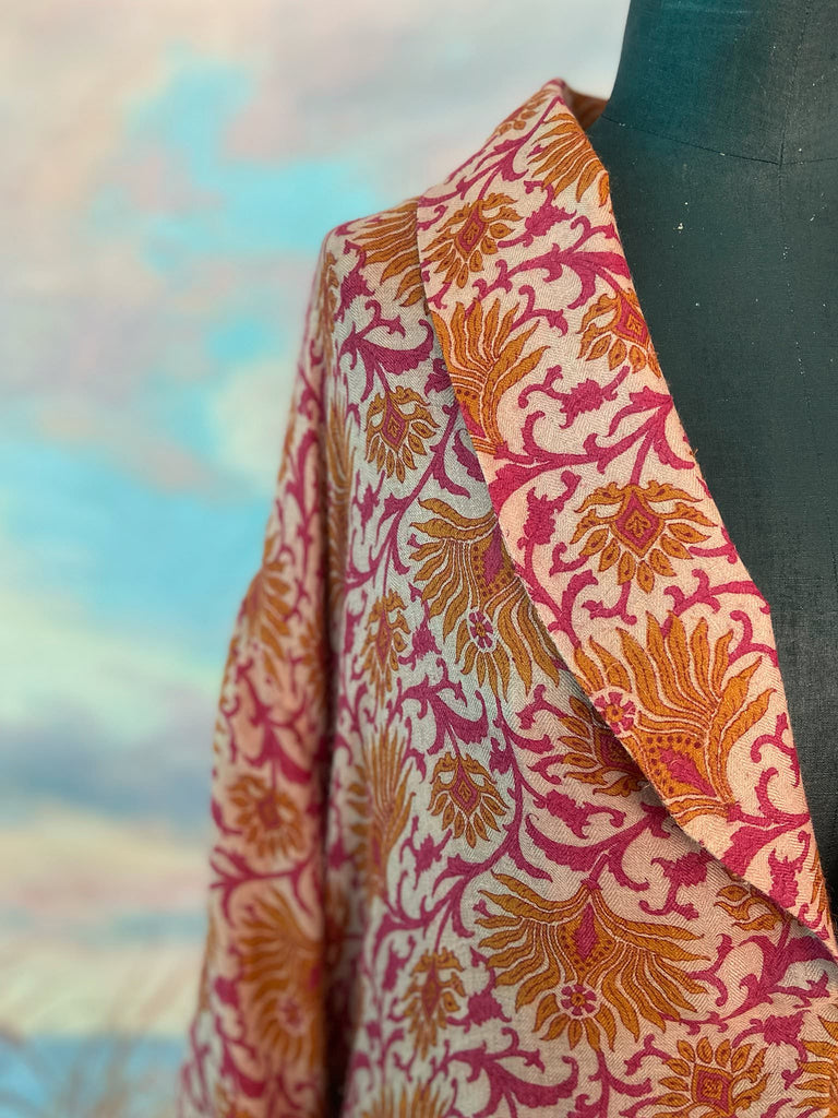 Saffron and hot pink fine wool dressing robe lined with silk. Wide sleeves, patch pockets and tassel sash belt. Bohemian styles sustainably created from antique and vintage textiles by the Pavilion Parade studio.