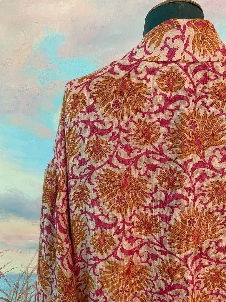Saffron and hot pink fine wool dressing robe lined with silk. Wide sleeves, patch pockets and tassel sash belt. Bohemian styles sustainably created from antique and vintage textiles by the Pavilion Parade studio.