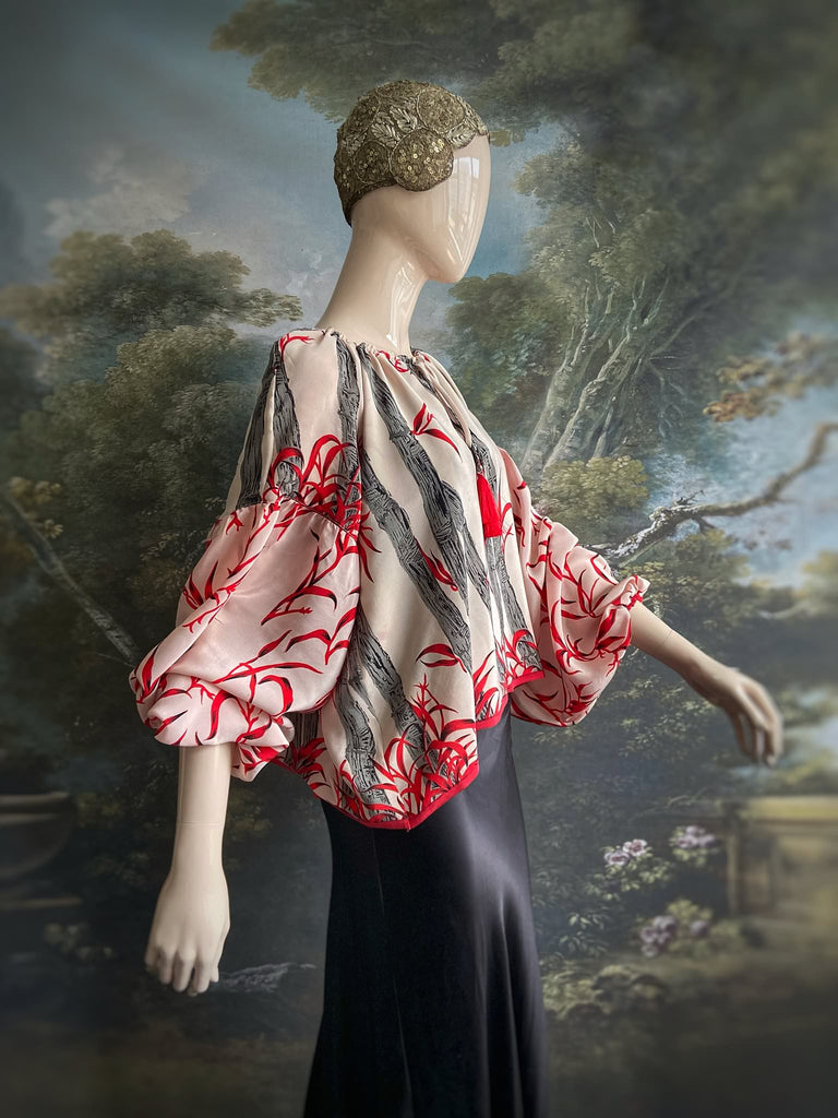 Scarlet, ivory and charcoal grey silk crepe blouse in a 1930s inspired bamboo print, with long full sleeves and adjustable drawstring neckline. Bohemian styles sustainably created from antique and vintage textiles by the Pavilion Parade studio. 