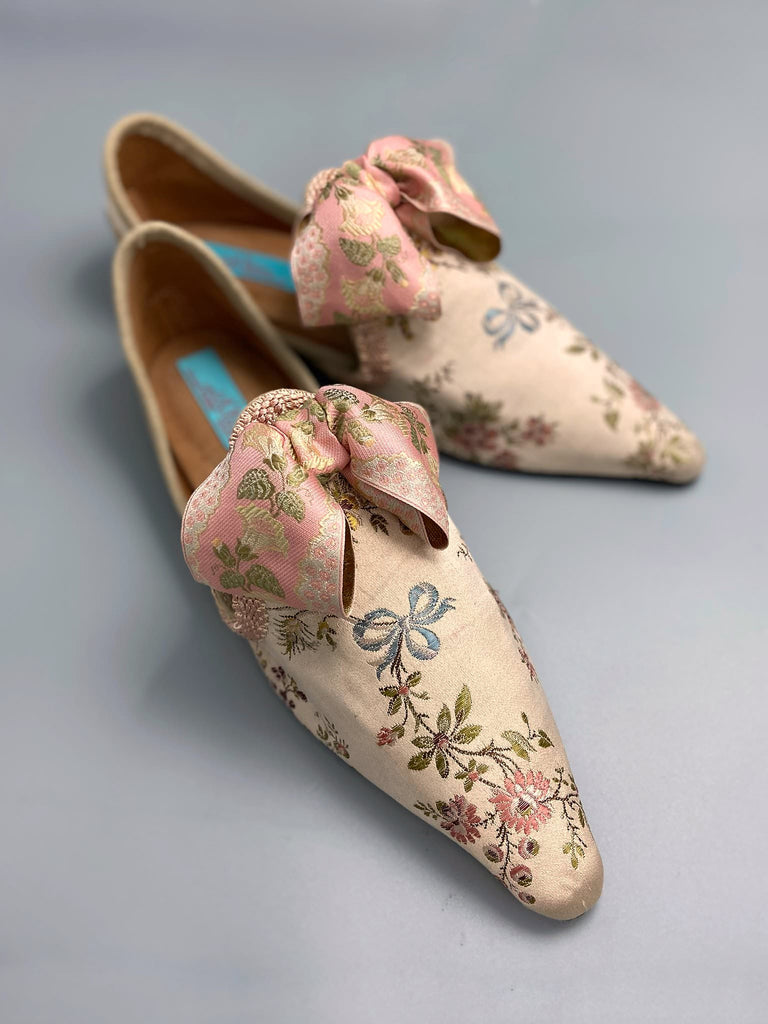 Creamy silk brocade poined toe flat shoes embellished with large blush pink silk ribbon bows. Bohemian style sustainably created from antique textiles from the Pavilion Parade studio.