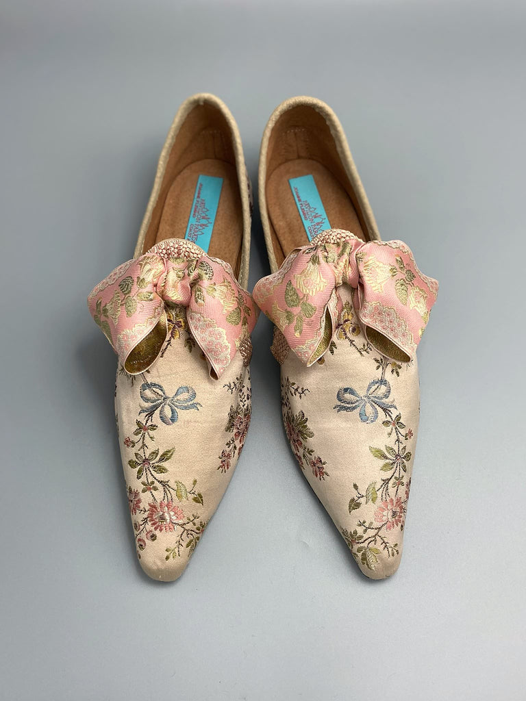 Creamy silk brocade poined toe flat shoes embellished with large blush pink silk ribbon bows. Bohemian style sustainably created from antique textiles from the Pavilion Parade studio.