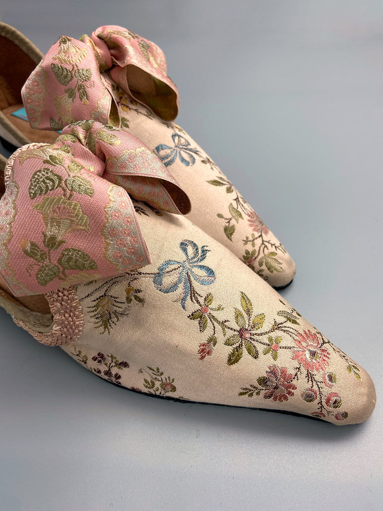 Creamy silk brocade poined toe flat shoes embellished with large blush pink silk ribbon bows. Bohemian style sustainably created from antique textiles from the Pavilion Parade studio.