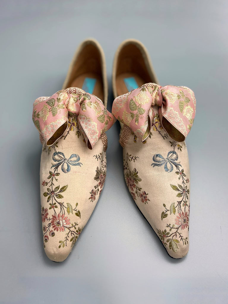 Creamy silk brocade poined toe flat shoes embellished with large blush pink silk ribbon bows. Bohemian style sustainably created from antique textiles from the Pavilion Parade studio.