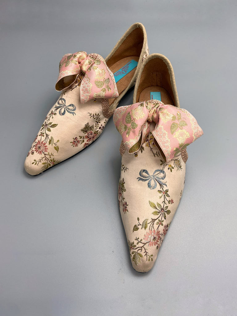 Creamy silk brocade poined toe flat shoes embellished with large blush pink silk ribbon bows. Bohemian style sustainably created from antique textiles from the Pavilion Parade studio.