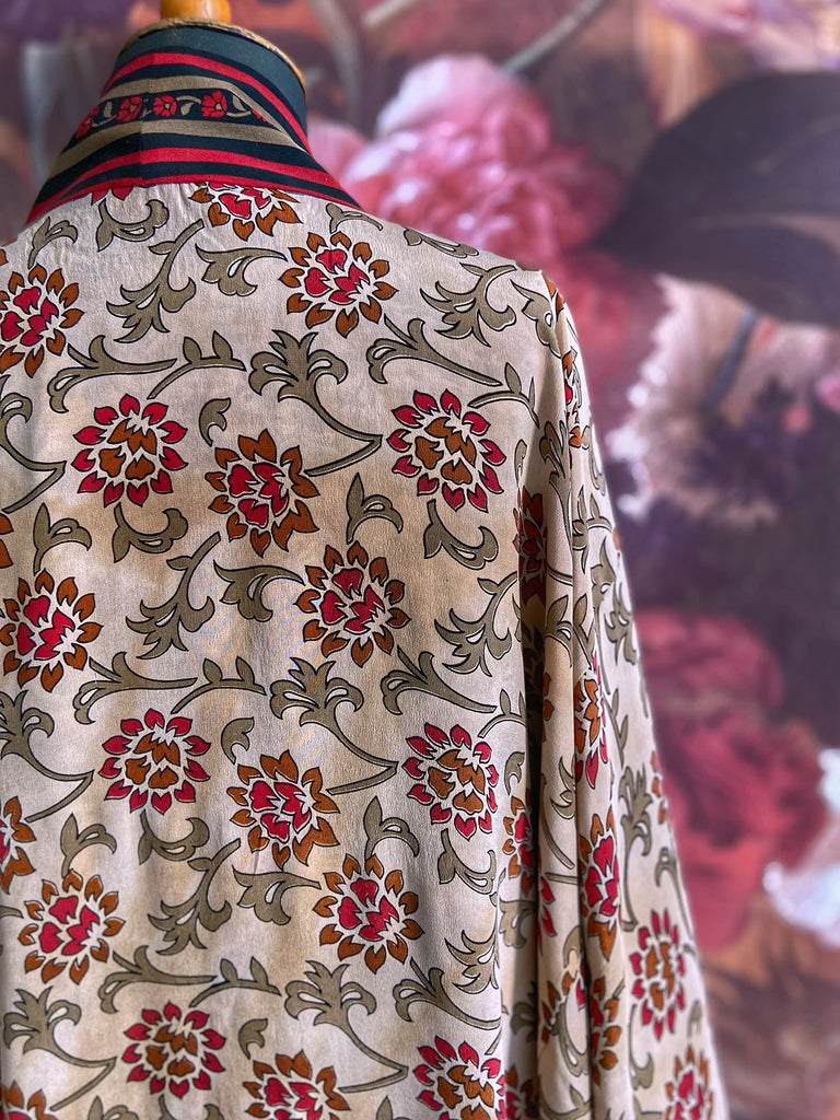 Full length 1920s inspired kimono robe with large patch pockets. Newly created from a red, black and stone vintage silk crepe. Fully lined in silk with French seams throughout. Bohemian styles sustainably created from antique and vintage textiles by the Pavilion Parade studio.