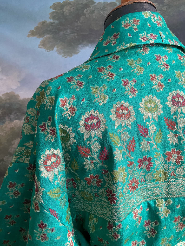 Turquoise green light silk brocade wrapper robe with full sleeves, large patch pockets and tassel sash. Bohemian style sustainably created from antique and vintage textiles by the Pavilion Parade studio.