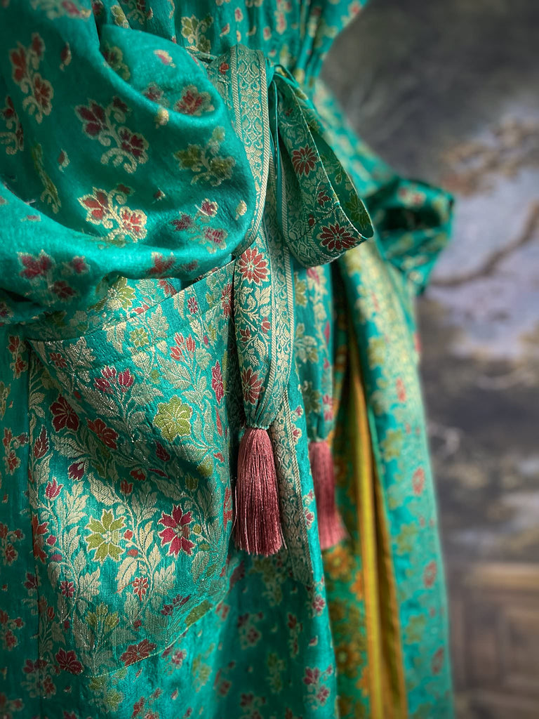 Turquoise green light silk brocade wrapper robe with full sleeves, large patch pockets and tassel sash. Bohemian style sustainably created from antique and vintage textiles by the Pavilion Parade studio.