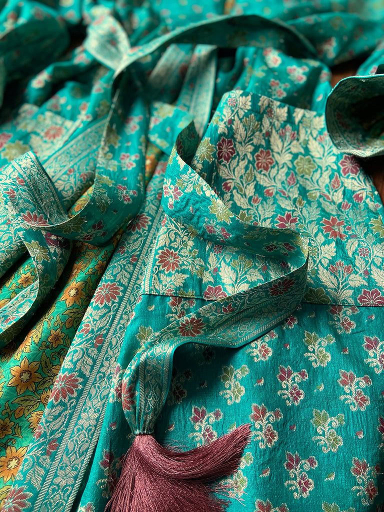Turquoise green light silk brocade wrapper robe with full sleeves, large patch pockets and tassel sash. Bohemian style sustainably created from antique and vintage textiles by the Pavilion Parade studio.