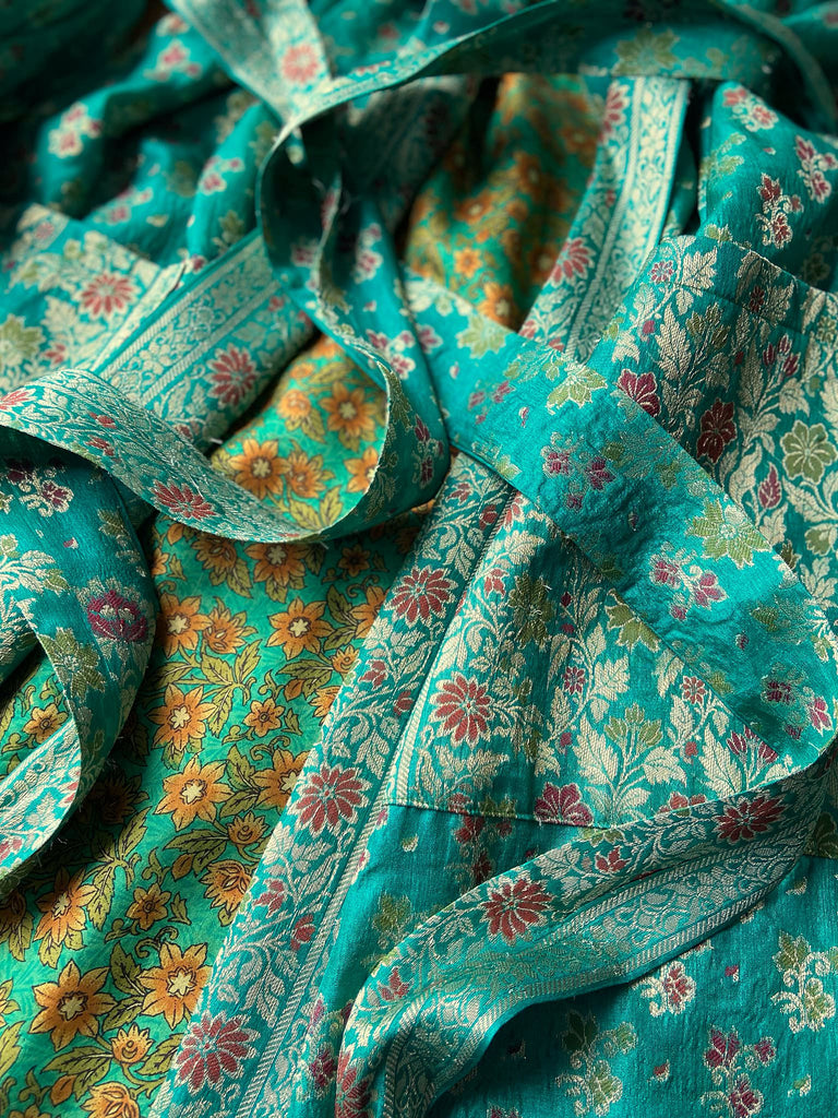 Turquoise green light silk brocade wrapper robe with full sleeves, large patch pockets and tassel sash. Bohemian style sustainably created from antique and vintage textiles by the Pavilion Parade studio.